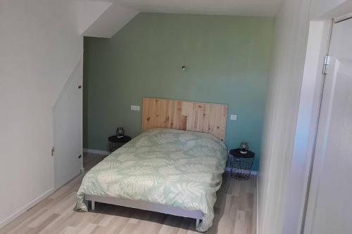 a small bedroom with a bed in the corner at Vue sur la chaine des Pyrénées in Lourdes
