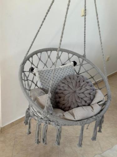 a hanging basket with a pillow and a pillow at PANTELI APART HOUSE in Aheloy