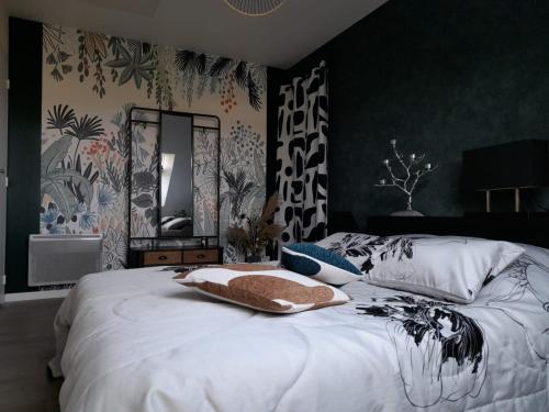 a bedroom with a white bed with a mirror at CHAMBRE DANS UN ECRIN DE VERDURE in Angrie