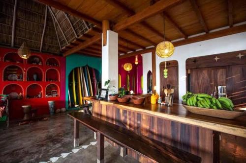 a bar with a bunch of bananas on a counter at Casa Love in Sayulita