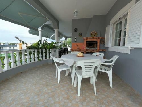 a white table and chairs on a balcony with a fireplace at Luxury Apartment 4 Bedrooms Pool in Marisol in Corroios