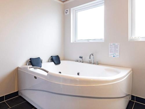 a white bath tub in a bathroom with a window at 6 person holiday home in Hirtshals in Hirtshals