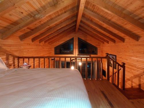 een slaapkamer met een bed in een houten kamer bij Koruwoodenhouse in Gazipasa