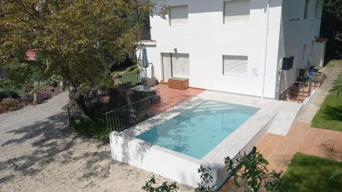 a swimming pool in front of a house at Casa La Quinta in Colindres