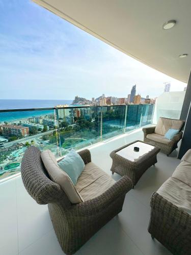 a balcony with chairs and a view of the ocean at Sunset Drive Vistas Magicas in Benidorm