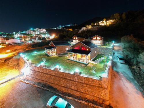 an aerial view of a building with lights at night at Koruwoodenhouse Alanya Gazipaşa in Gazipasa