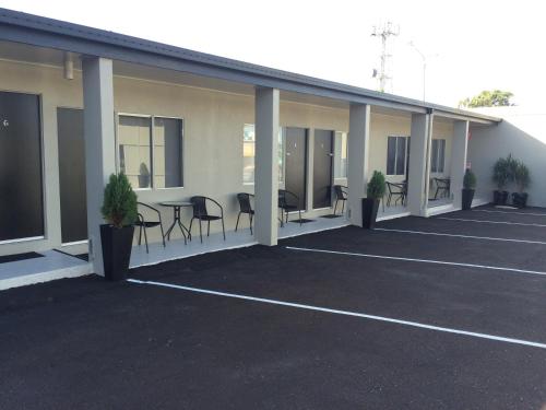 an empty parking lot with chairs and a table at Original North Australian in Bowen