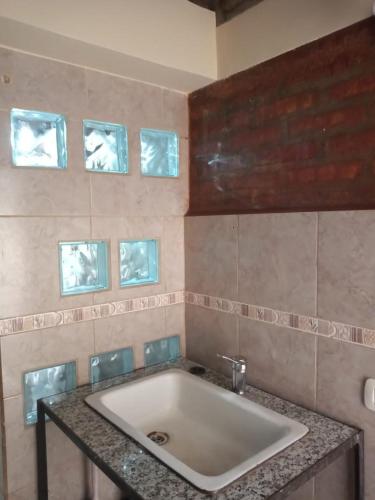 a bathroom with a white sink in a room at Emilia I in Esquel