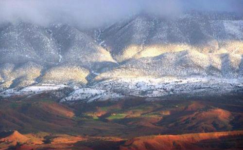 an aerial view of a mountain range with snow at Atlas AGUELMAM in Bine el Ouidane