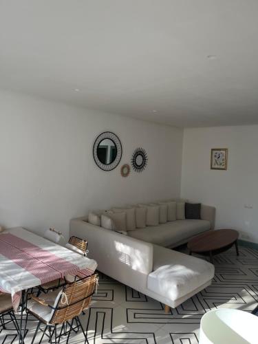 a living room with a couch and a table at Atlas AGUELMAM in Bine el Ouidane
