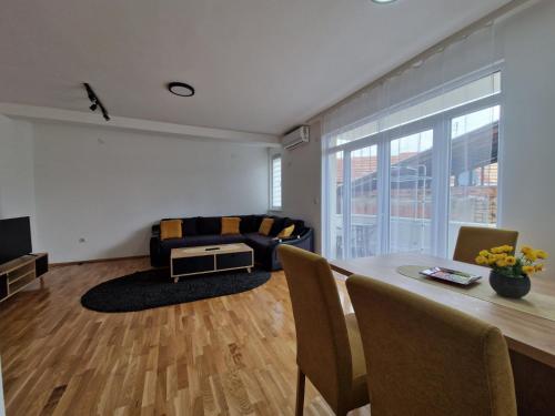 a living room with a table and a couch at N&M Apartment in Pirot