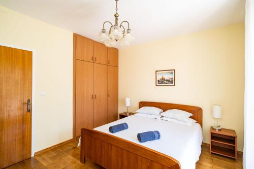 杜布羅夫尼克的住宿－耐克客房及公寓，一间卧室配有一张带两个蓝色枕头的床