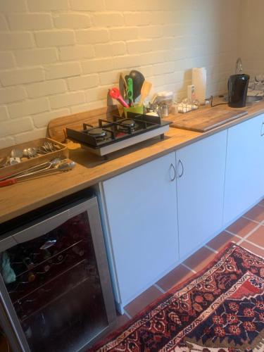 a kitchen counter with a stove top oven at Villa Paulina Family Suite in Langebaan