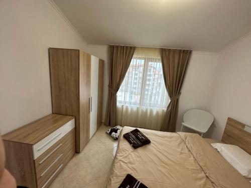 a bedroom with a bed and a window at PANTELI APART HOUSE in Aheloy