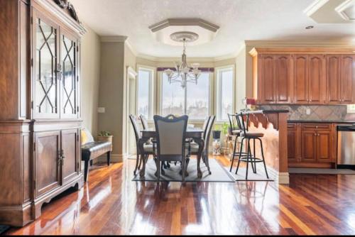 a kitchen with a table and chairs in a room at Royal highland livingroom bedroom suite in Calgary