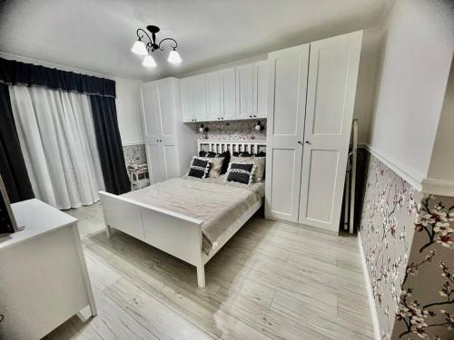 a bedroom with a bed and a large white cabinet at Sea angel in Burgas City