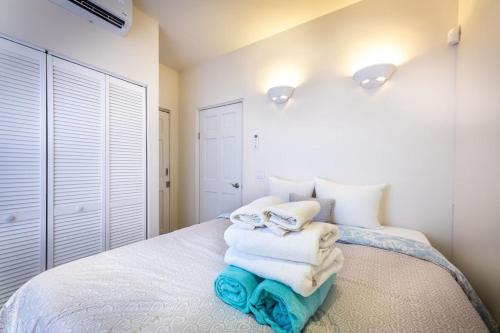 a bedroom with a bed with towels on it at Downtown Dreamstay, Classic 2BR Suites in Willemstad