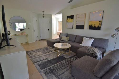 a living room with a couch and a table at Florinda 3bdr/2bth 2car garage with New Pool in Sarasota