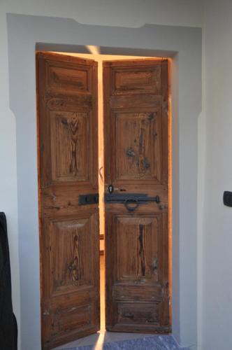 a pair of wooden doors in a room at VILLA VINICIA, pool, jacuzzi, airco in Domaso