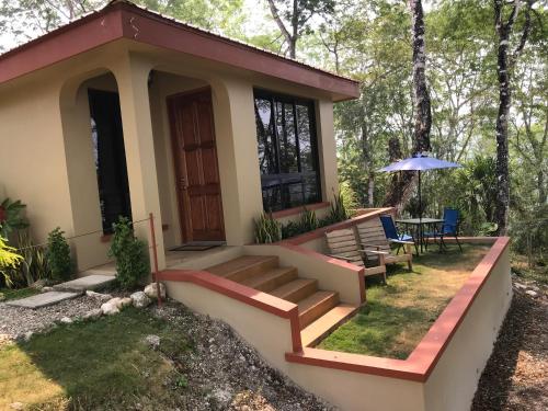 a small house with a porch and a patio at Villa Cayo in San Ignacio