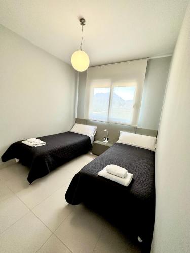 a bedroom with two beds and a window at Sunset Drive Vistas Magicas in Benidorm