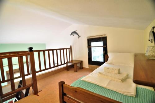 A bed or beds in a room at Zennova #23 Nikiti Family Green Nest