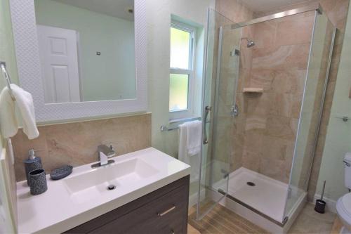 a bathroom with a sink and a shower at New England 3bd 2bt Home Heated Pool Close to Siesta in Sarasota