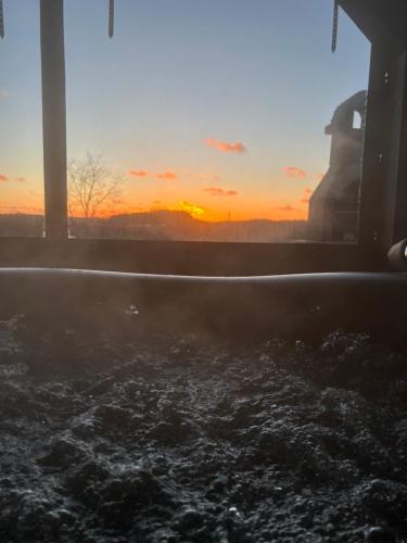 a view of the sunset from a bath tub at Apartament Nadziei in Chmielno
