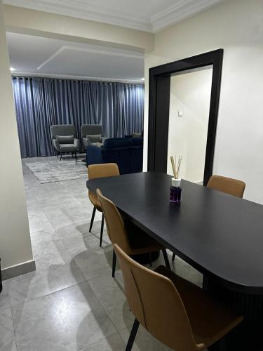 a conference room with a table and chairs and a couch at Modern City Center 3-Bed Apartment in Abuja