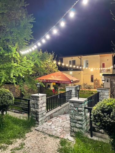 a garden with a fence and a patio with a tent at Garden Hotel Pasanauri since 1892 in Passanauri