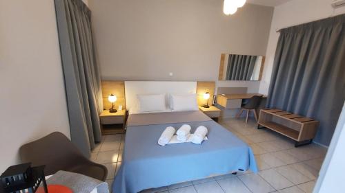 a bedroom with a bed with two towels on it at Stelios Studios Sougia in Sougia