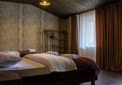 a bedroom with two beds and a window at Hotel Eden in Mestia