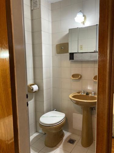 a small bathroom with a toilet and a sink at Hotel Americano in Buenos Aires