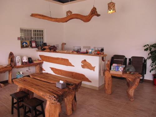 a room with a wooden table and bench in it at Woodenfish in Chenggong