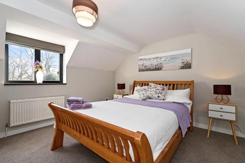 a bedroom with a large bed and two windows at Stunning Detached House in Bassett in Southampton