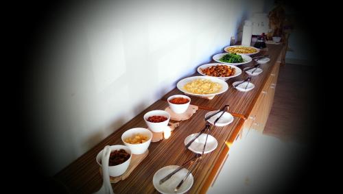 a long wooden table with many different dishes of food at Woodenfish in Chenggong