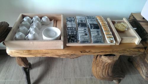 a wooden table with vases and other items on it at Woodenfish in Chenggong