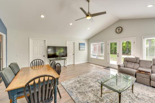 a living room with a table and chairs and a tv at Charming Bluffton Vacation Home with Yard! in Bluffton