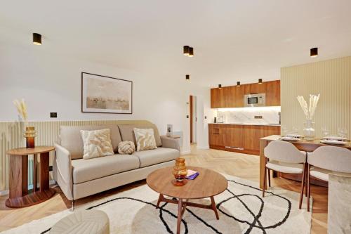 ein Wohnzimmer mit einem Sofa und einem Tisch in der Unterkunft Luxury appartement 1BR 4P - Petits Champs in Paris