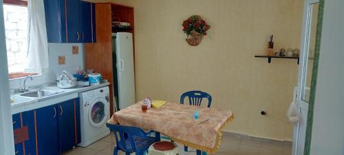 a kitchen with a table and a washing machine at ESKA 121 airport in Dalaman