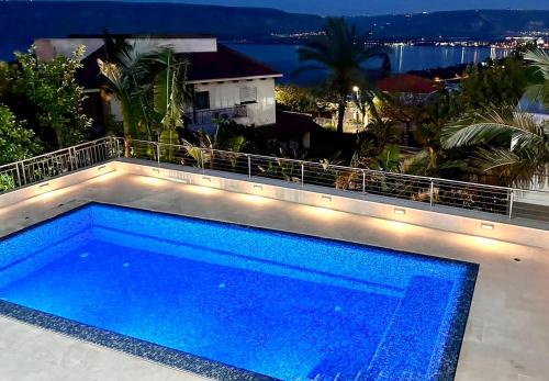a swimming pool with lights on top of a building at Kinneret View in Kinneret