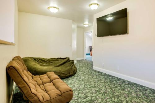 a living room with a couch and a flat screen tv at Spacious Hildale House with Large Deck! in Hildale