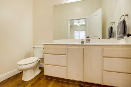 a bathroom with a toilet and a sink and a mirror at Spacious Hildale House with Large Deck! in Hildale