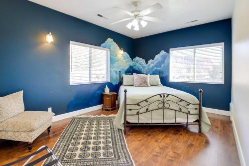 a bedroom with blue walls and a bed and a chair at Spacious Hildale House with Large Deck! in Hildale