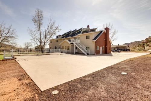 a house with a large driveway in front of it at Spacious Hildale House with Large Deck! in Hildale