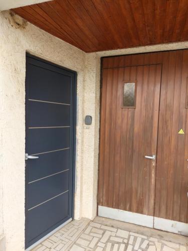 a garage with a wooden door and a wooden ceiling at Les mésanges in Laquenexy