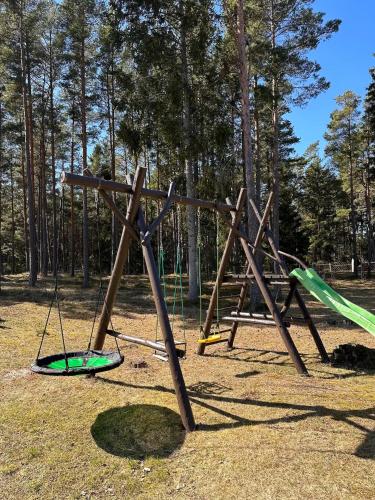 a playground with a swing set in a park at My little happy place in Undva