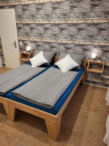 a bed in a room with a wooden wall at Ferienhaus Budenheim in Budenheim