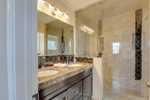 a bathroom with two sinks and a shower at 3 Mi to Casinos Reno Home with Fenced Yard! in Reno