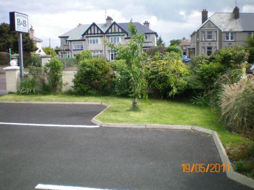 a parking lot in front of a house at Aaranmore Lodge Guest House in Portrush